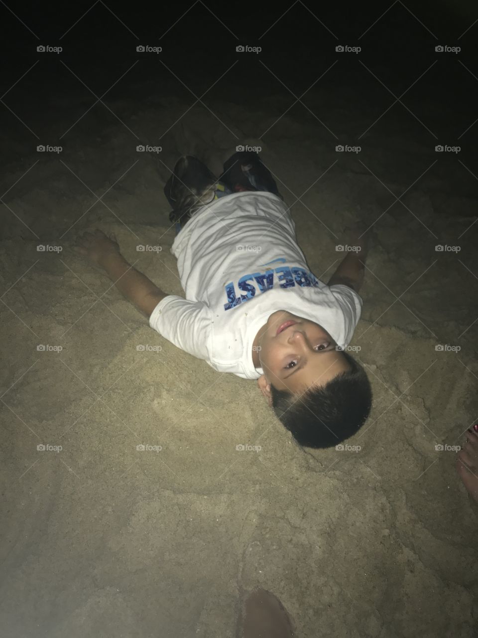 4th July, on his back in the sand waiting for the fireworks!
