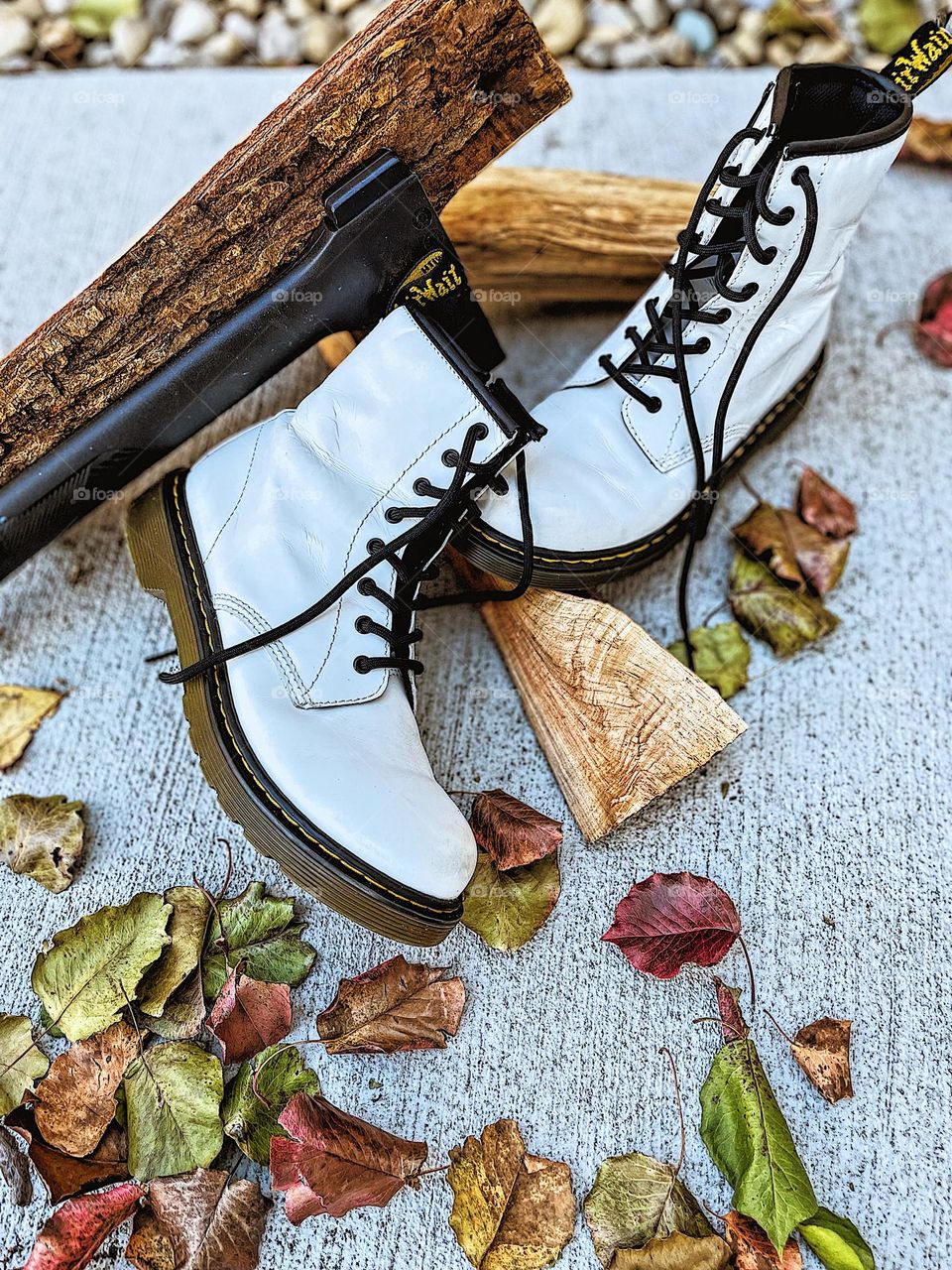 Doc Marten boots with logs and ax, Dr. marten boots outside, using Docs for functionality, Doc Marten boots in the woods, nature and Doc Martens, chopping wood with Docs, boots and lumberjacks, working class boots