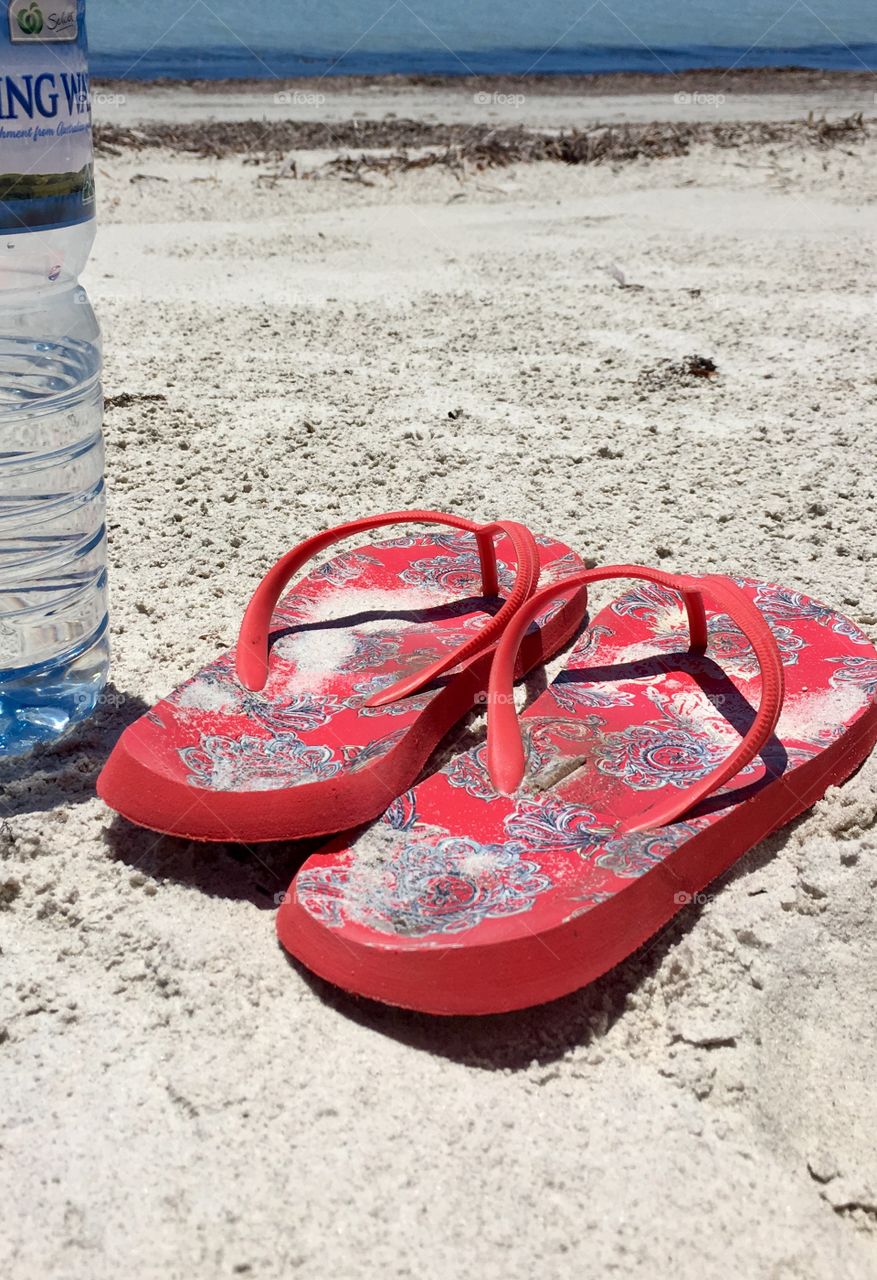 Red sandals on the beach