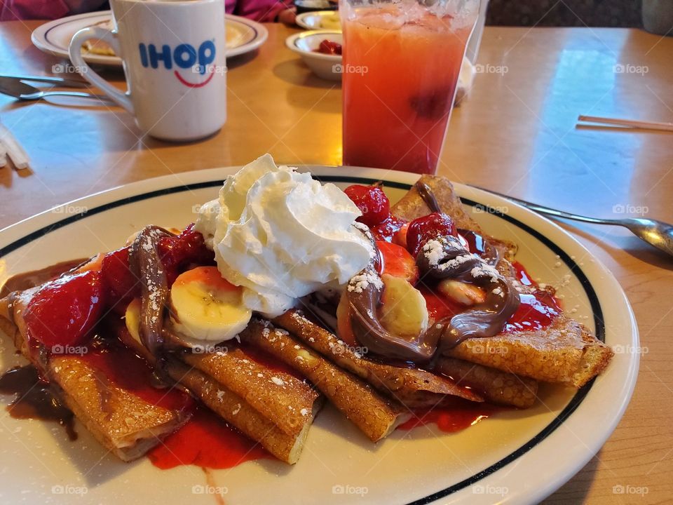 Favorite IHOP meal. Crepes with strawberries, bananas, and Nutella. Fruit Splasher to help it slide down.