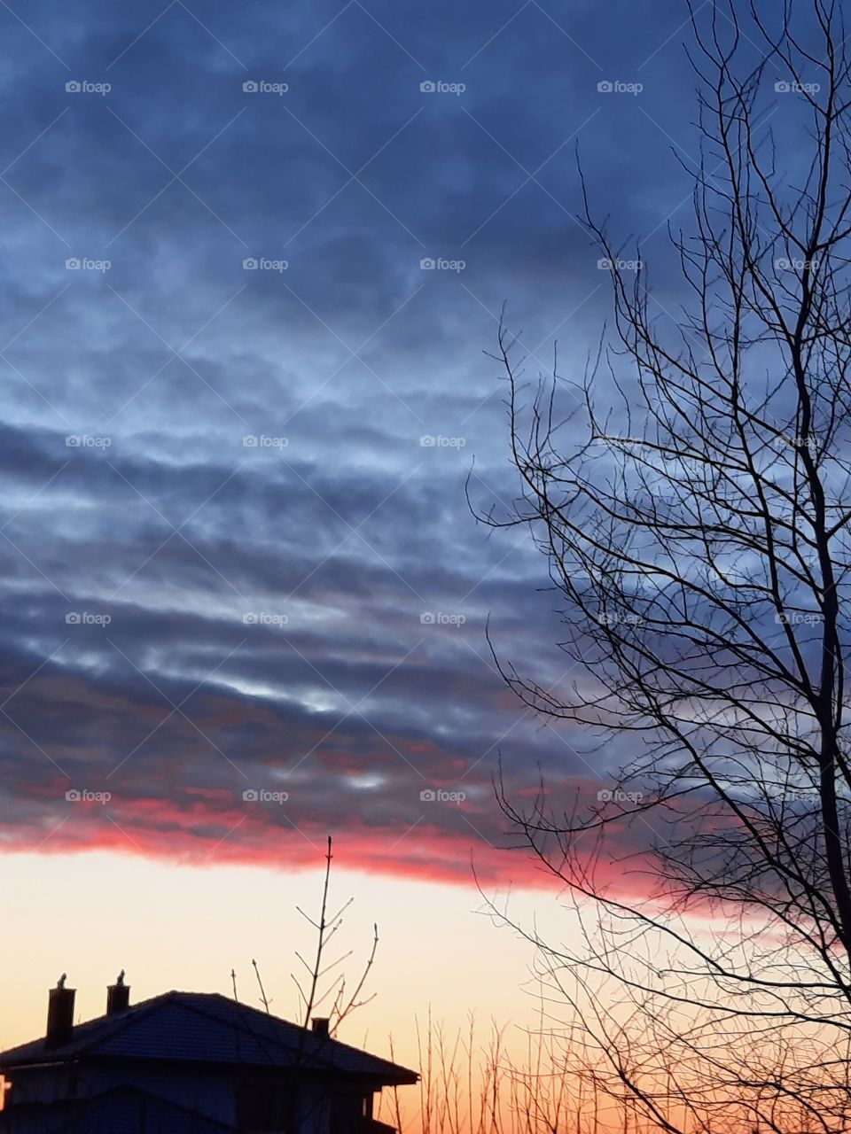 rising sun is painting heavy dark clouds at dawn