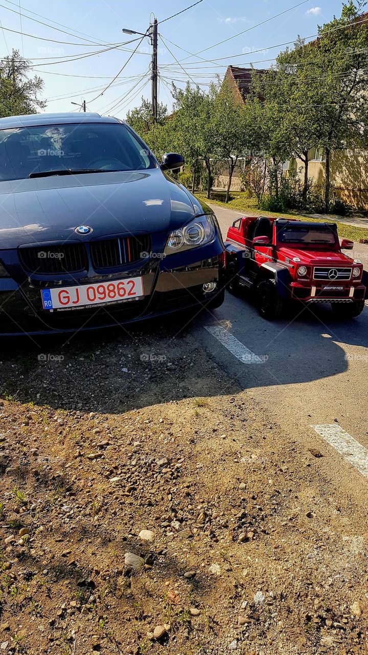 a big car next to a small car