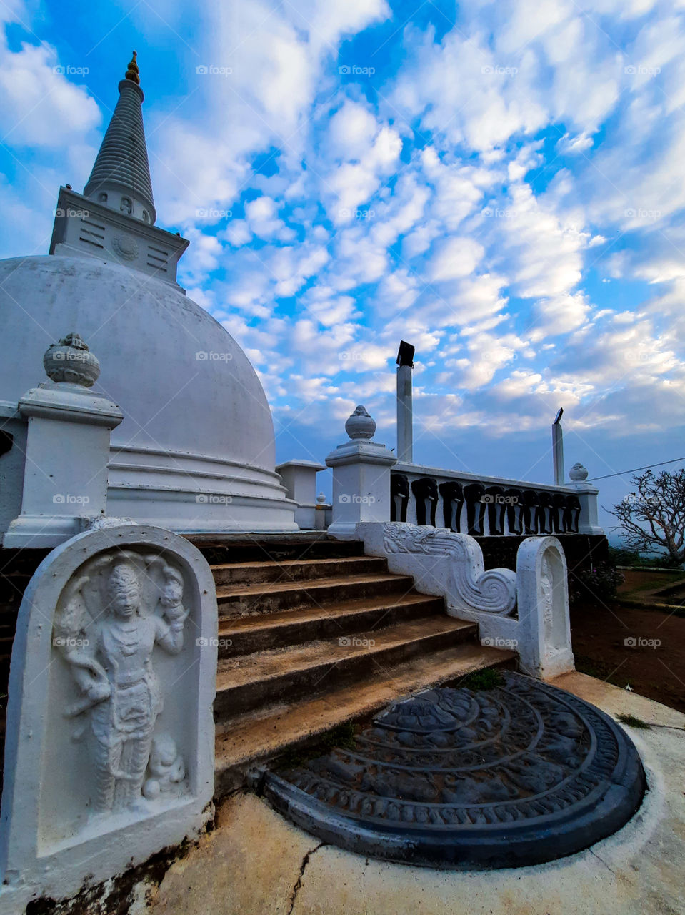 A morning view of an ancient pagoda with colourful skies in the northern part of Sri Lanka. This pagoda sits upon a beautiful hill with jungle all around making some of most beautiful and peaceful surroundings.