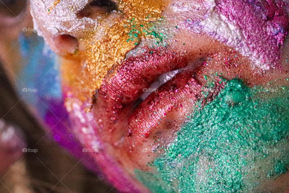 A child wearing glitter makeup