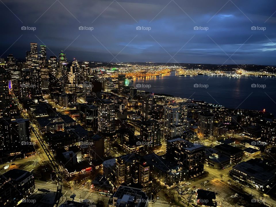 Aerial view of Seattle skyline - City night lights under a cloudy sky