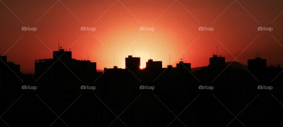 City buildings silhouettes by sunset