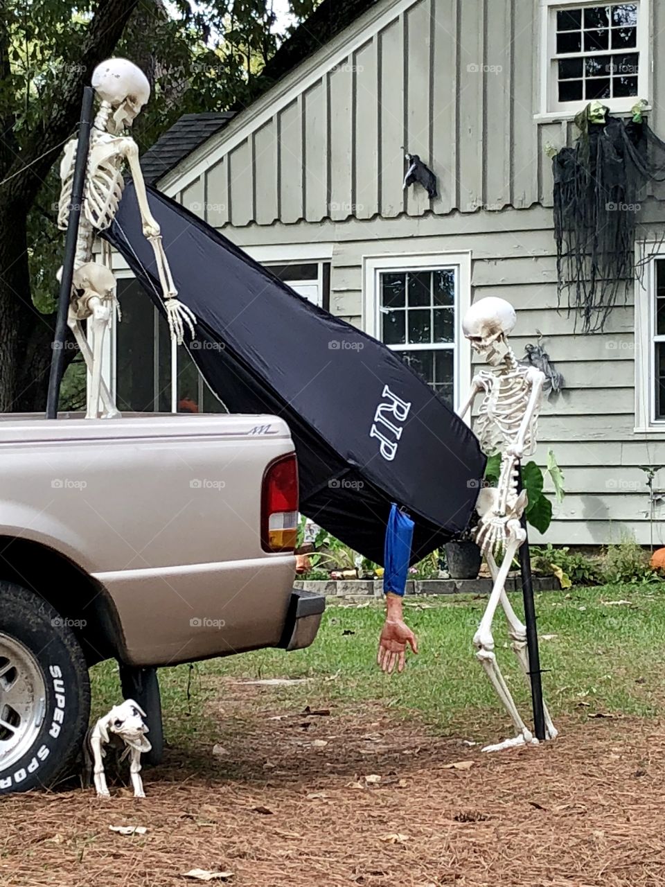 Someone got really creative with their Halloween yard setup; they use their own vehicles for a tiny touch of realism.