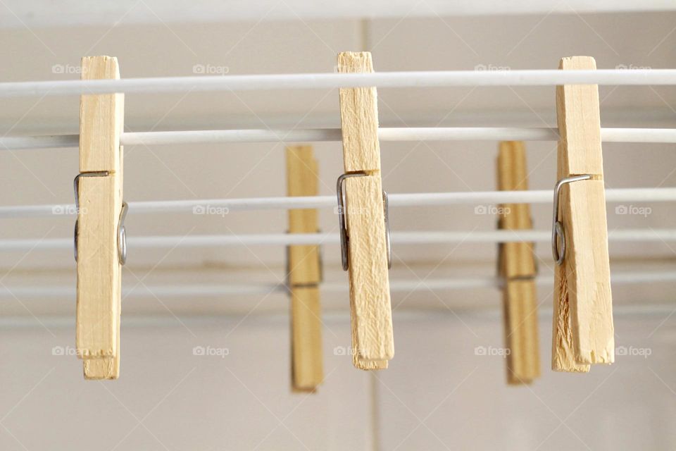 wooden clothespin on metal clothesline