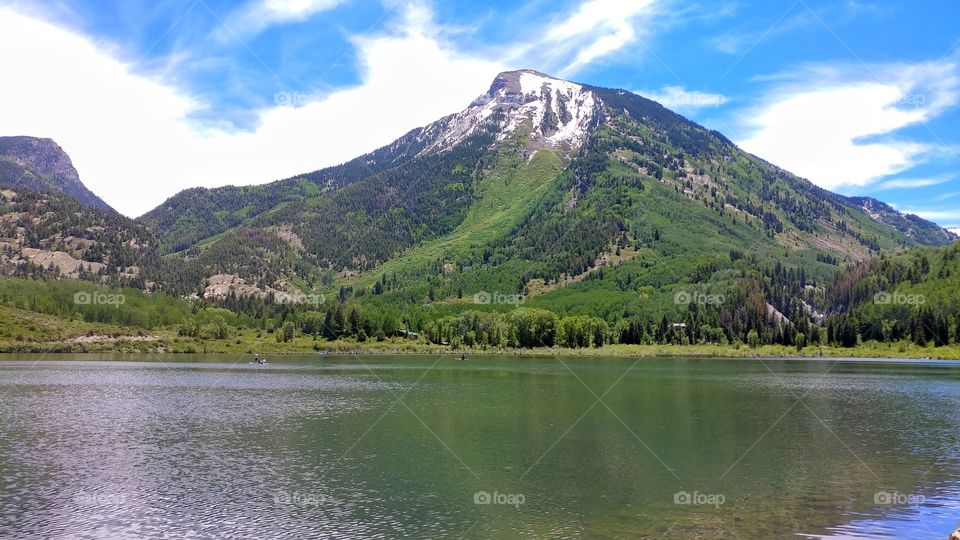 Beautiful Bever Lake reflects a near by mountain in its green waters.