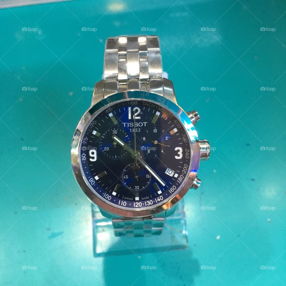 Blue dial analogue chronograph day date time stopwatch stainless steel band Tissot wrist watch