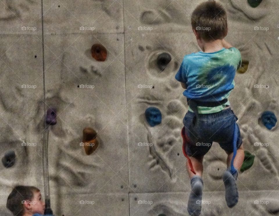 Boy Learning To Use Climbing Gear