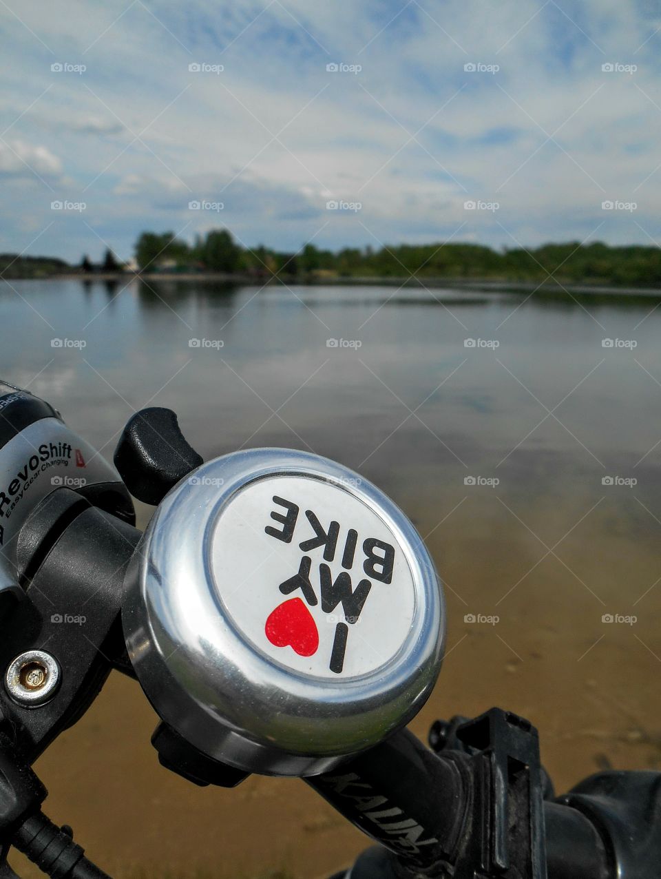 l love my bike on a lake shore beautiful spring landscape sky clouds background