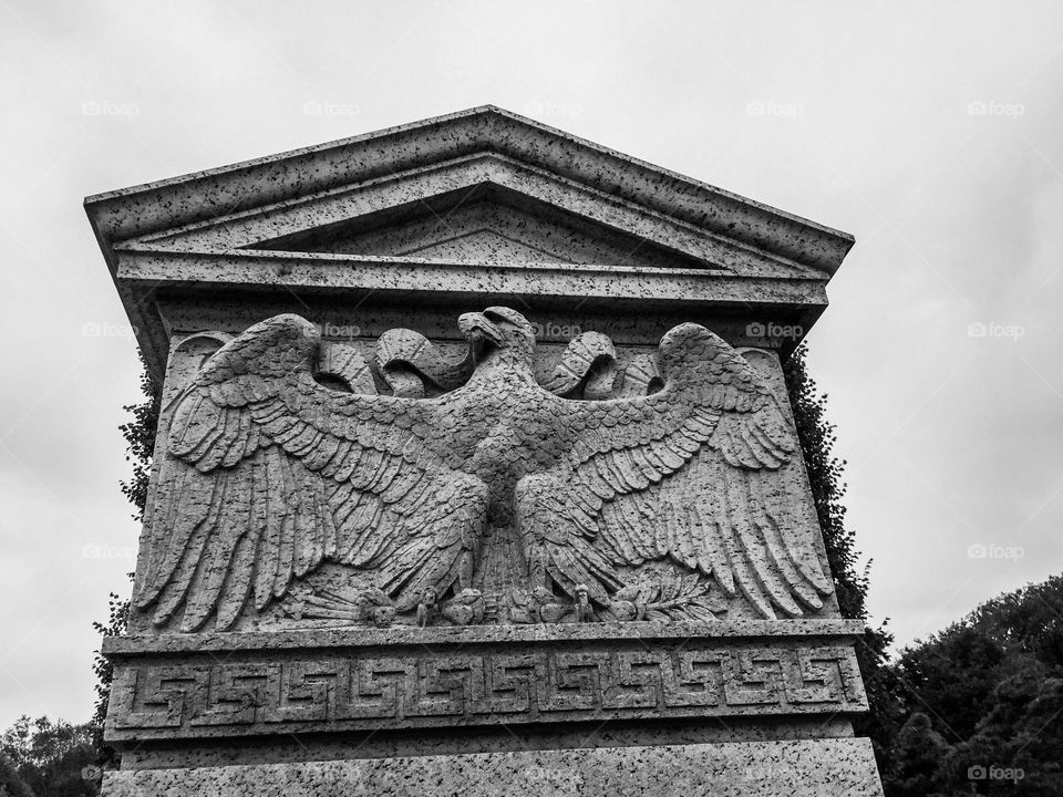 Black and white photo of a piece of stone inscribed with an American eagle 