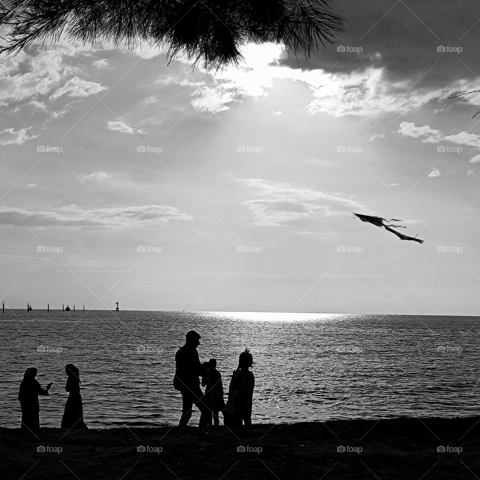 Flying a kite on the beach.