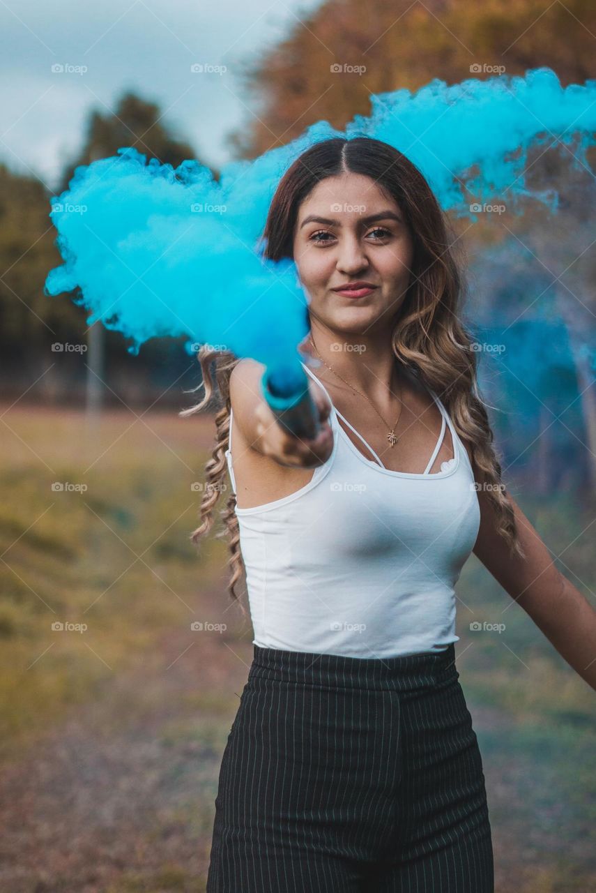 Photograph of girl playing with smoke bombs