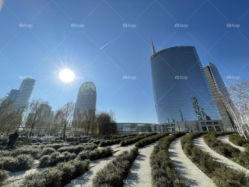 Sunny morning in a city park of Milano with the sun in a perfect blue Sky, winter time 
