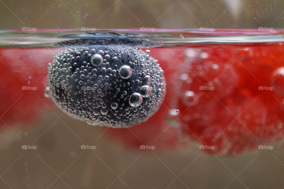 Liquid Mission ... Blueberry and raspberries floating in fizzy liquid 