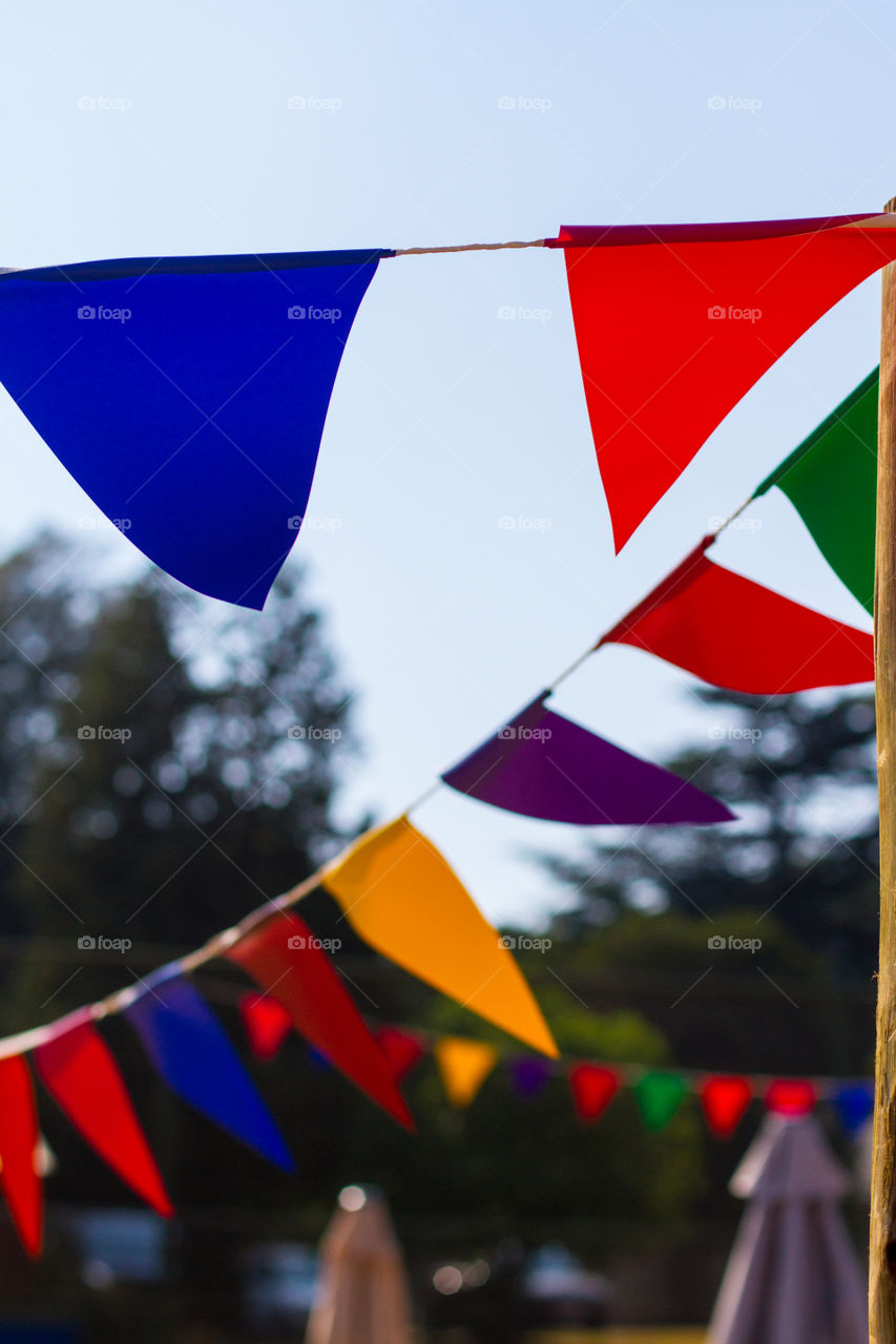 Colorful banting flags in the wind. Different color flags outdoors.