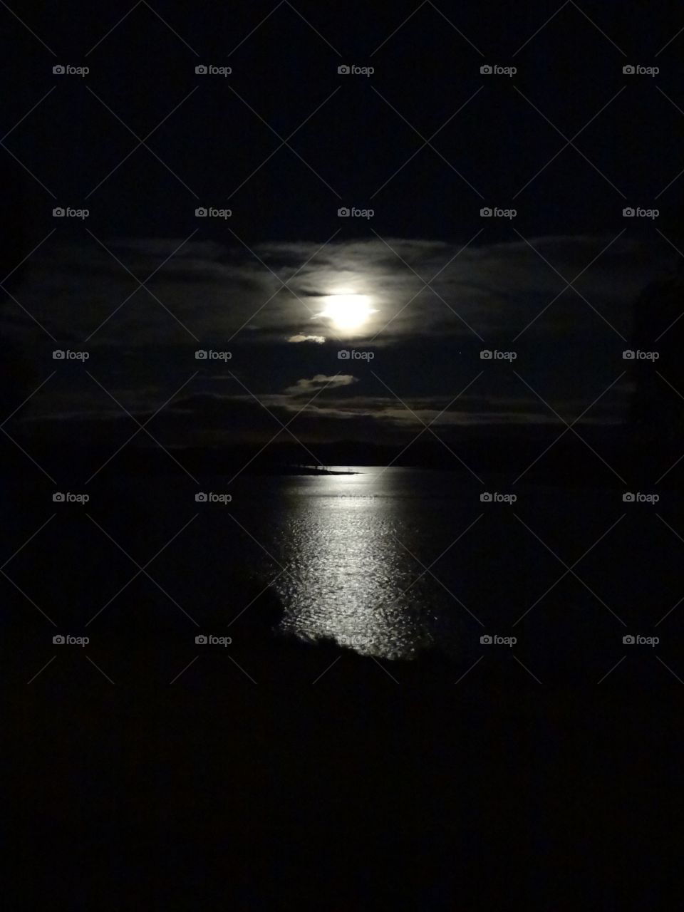 Night shot of moon over water 