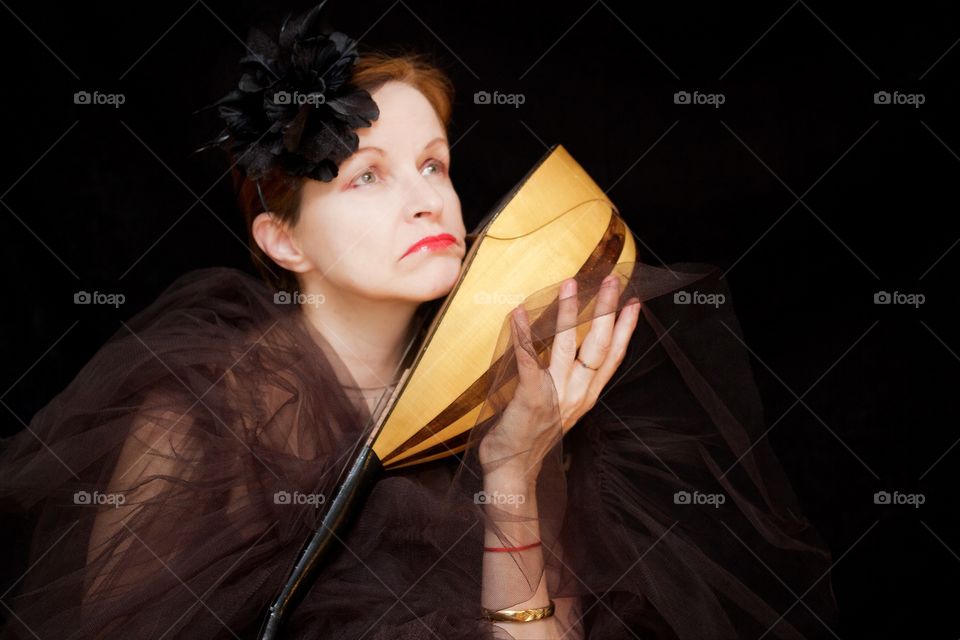 Close-up of a woman holding mandolin in hand