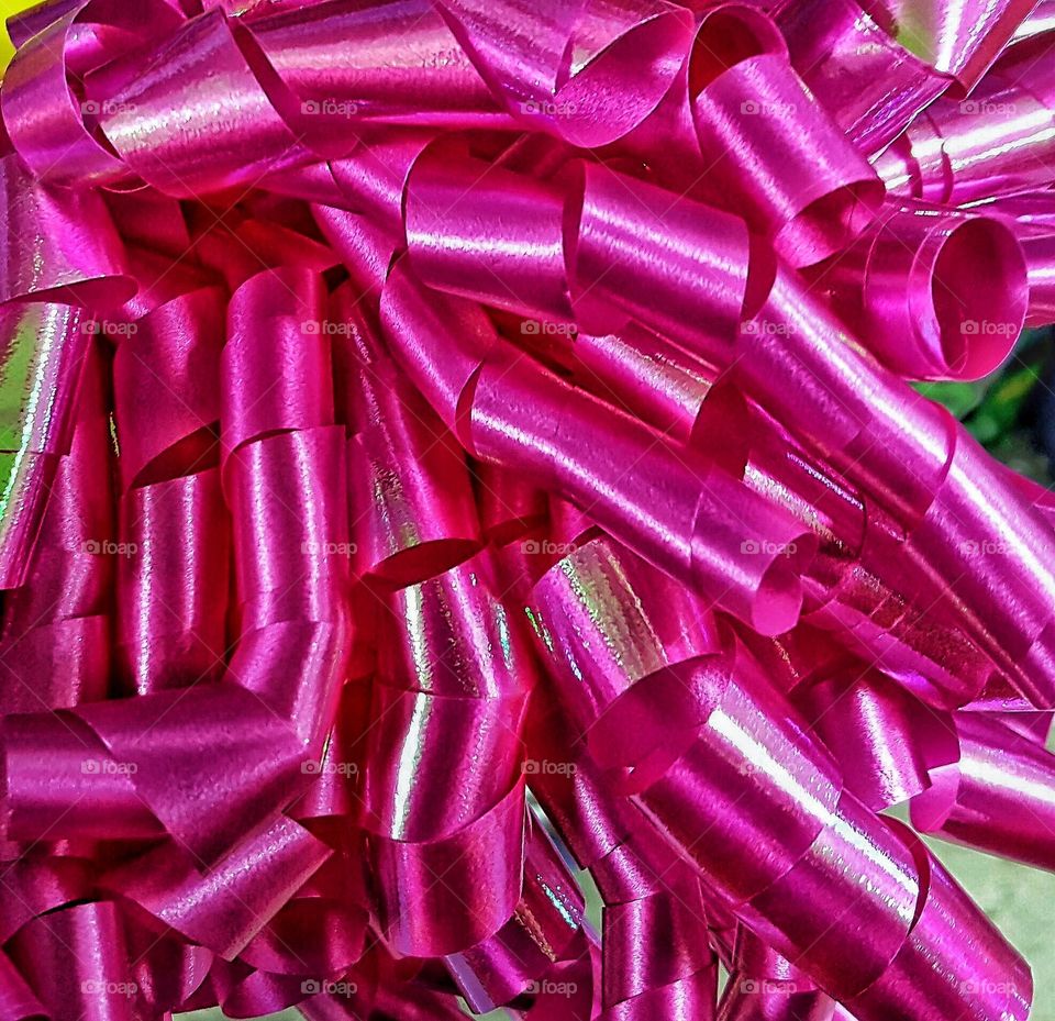 Close-up of pink curled ribbons