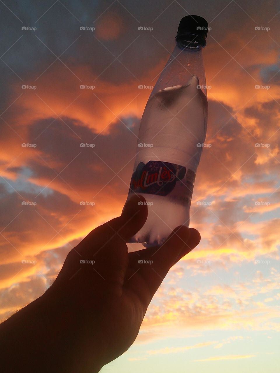 Magic sunset and a beautiful bottle embraces high sky.