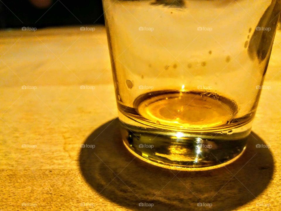 empty beer glass on golden background