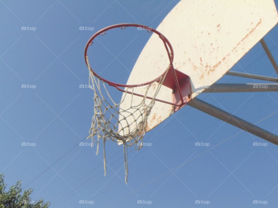torn basketball hoop at a school 