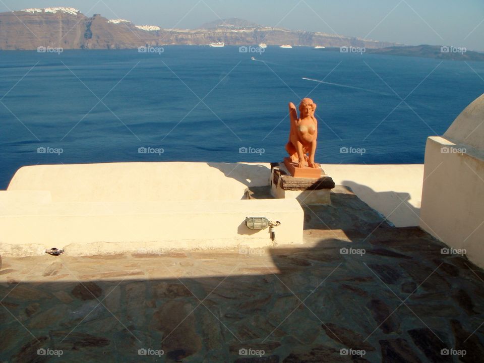 the sea the mountains and one statue