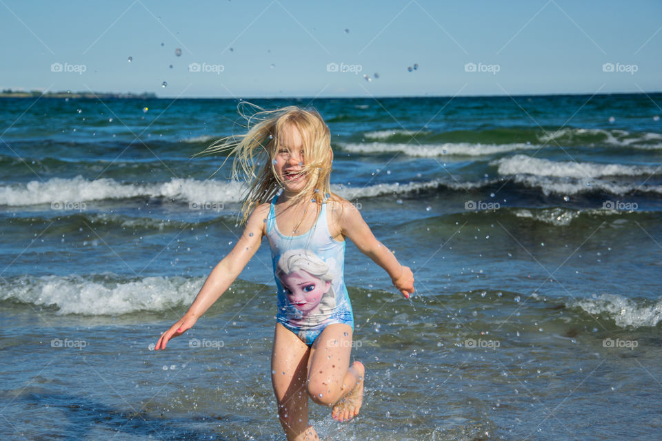 Girl running in sea