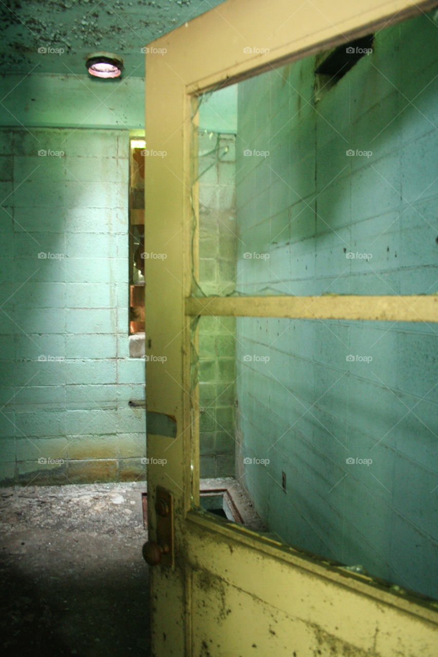 A broken yellow door in an abandoned building