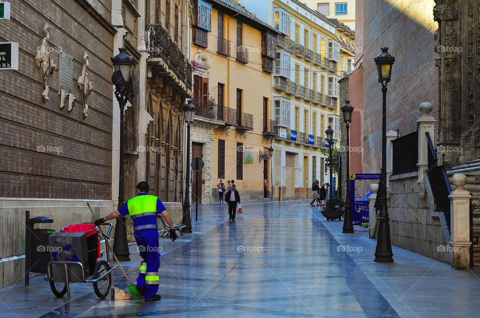 Empty street in the morning and men cleaning the street 