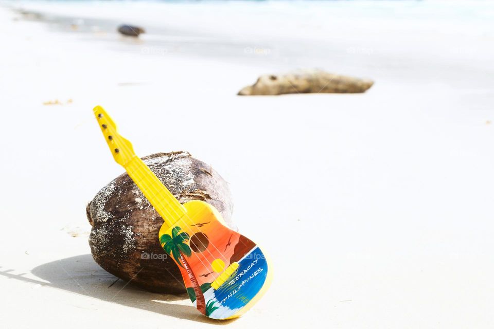 small guitar on beach 