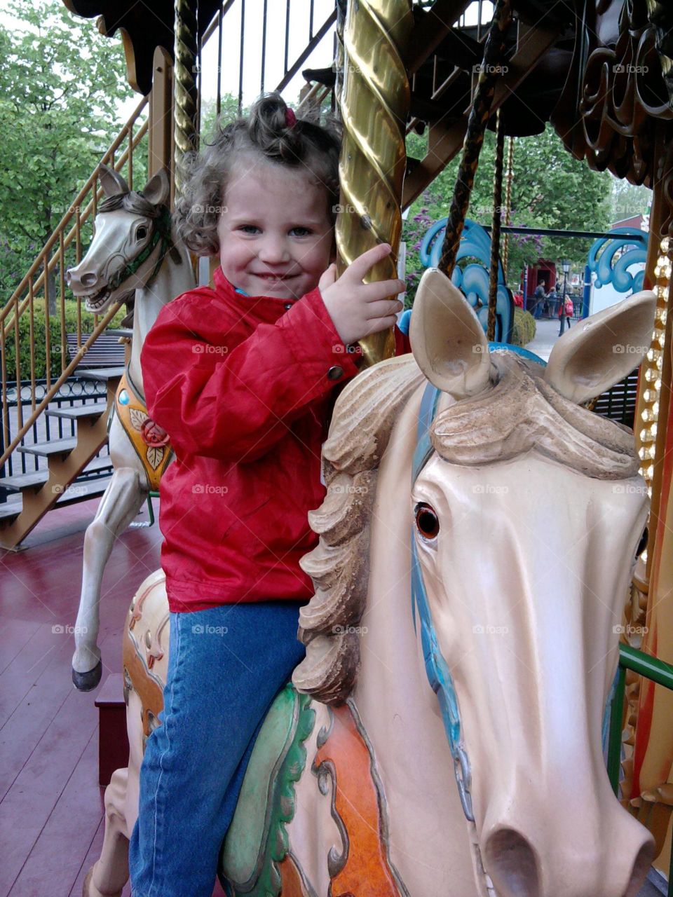 My beautiful little girl on a horse in the attraction park
