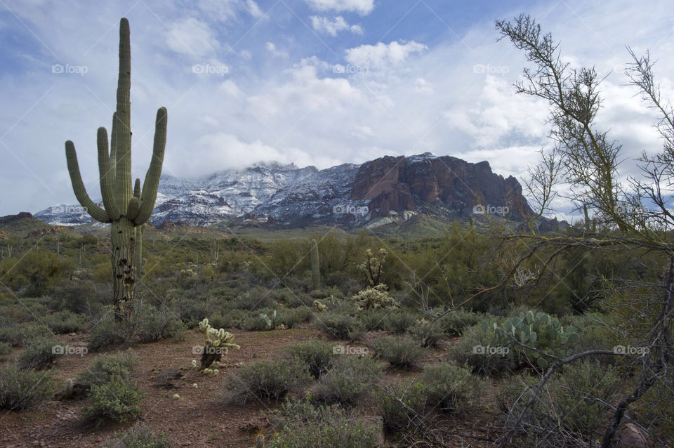 Storm clouds hover over the Superstition Mountains in Arizona as a