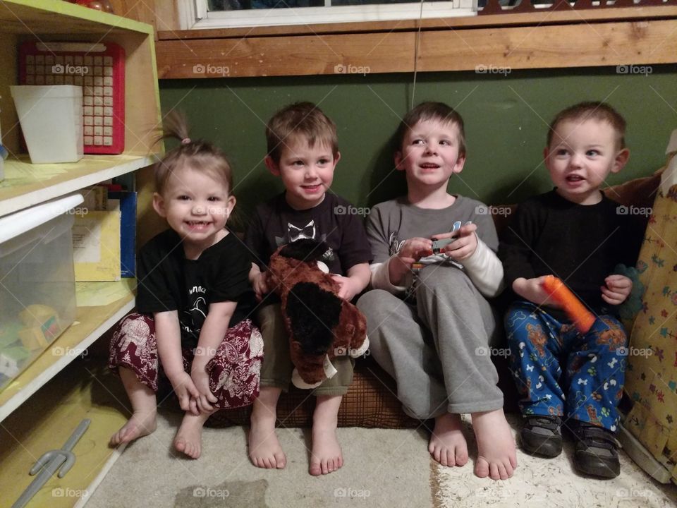 Group of children sitting at home with toys