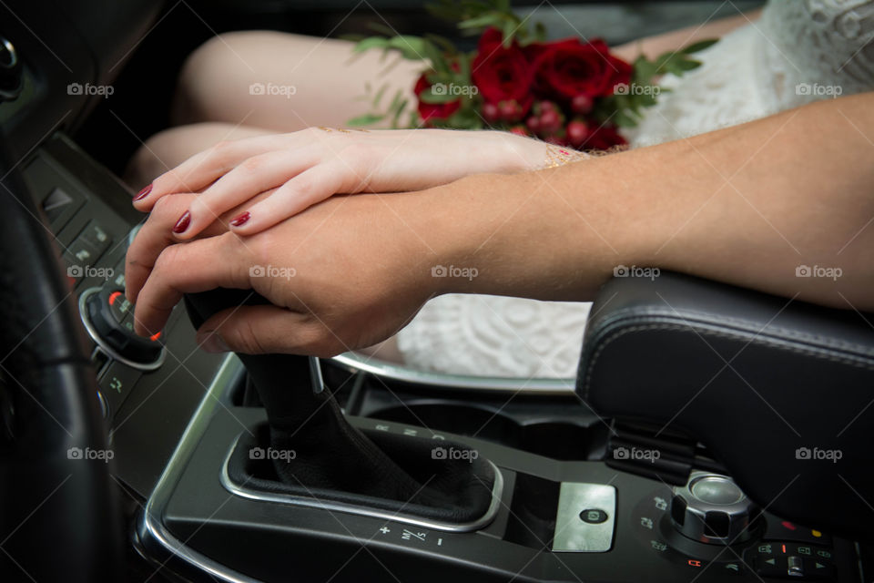 hands. just married in car