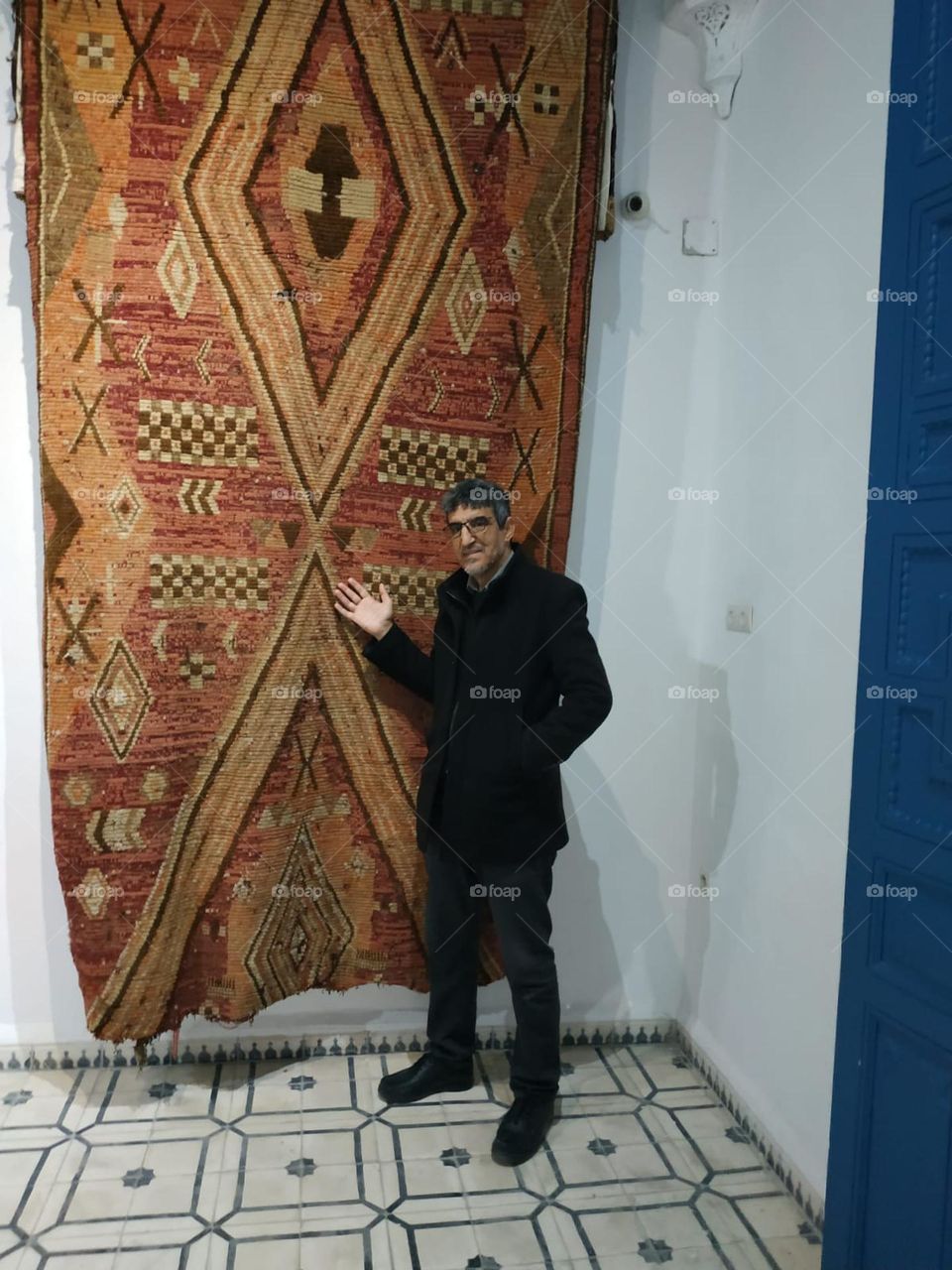 Im standing near an ancient moroccan carpet.