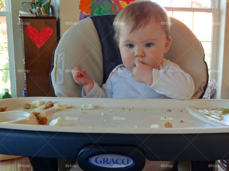 Baby Eating In A Highchair