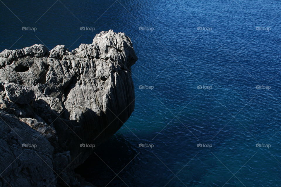 rock in blue sea