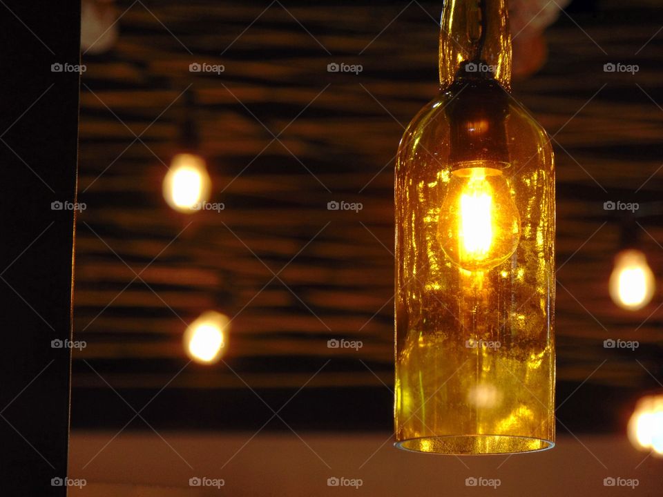 a lightbulb inside a bottle hanging from the ceiling