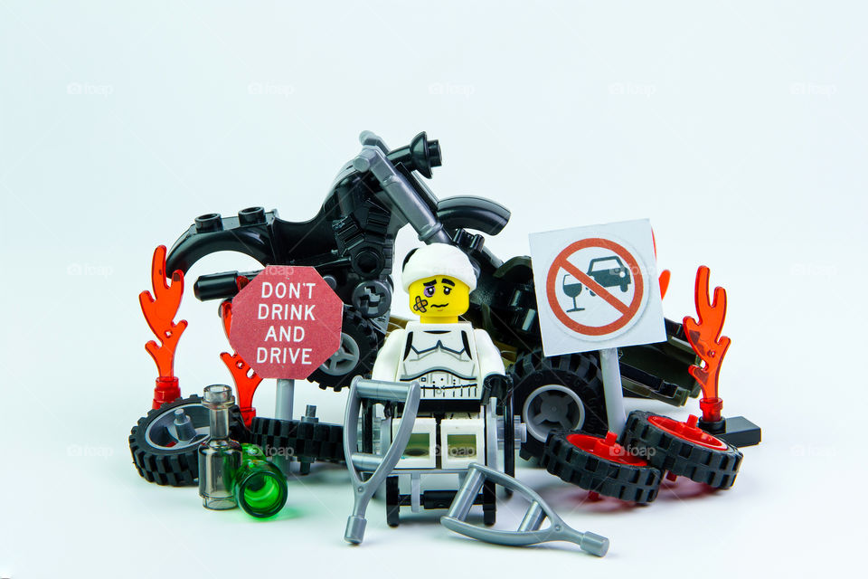 Nonthabure, Thailand - August, 08, 2016 : Lego star wars stormtrooper accident by a drunk driver and a sign Drink don't drive. isolated on white background.Lego is an interlocking brick system collected around the world.