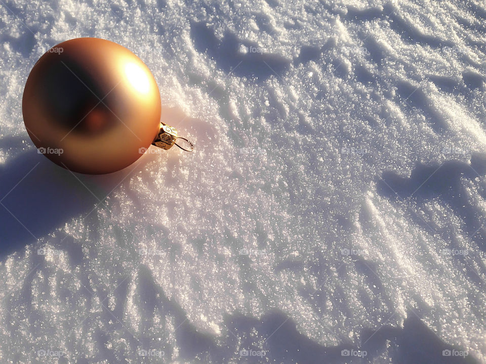 Christmas sphere on snowy background 