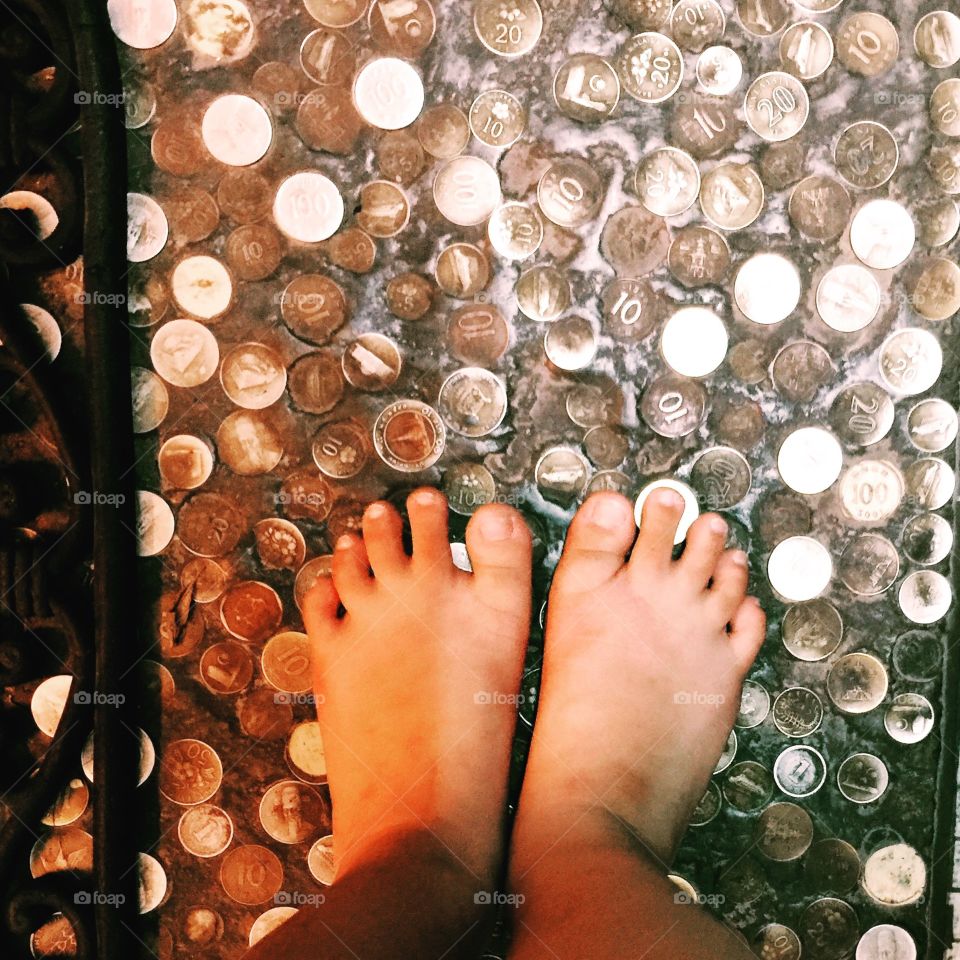 foot view. foot view and coins on the floor