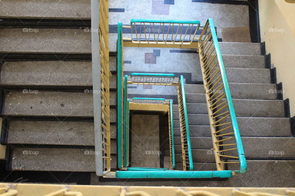 Vintage old concrete staircase in a block top view spiral point of view