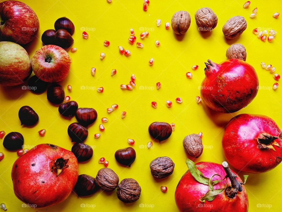 flat lay with pomegranate chestnut nuts and autumn fruit