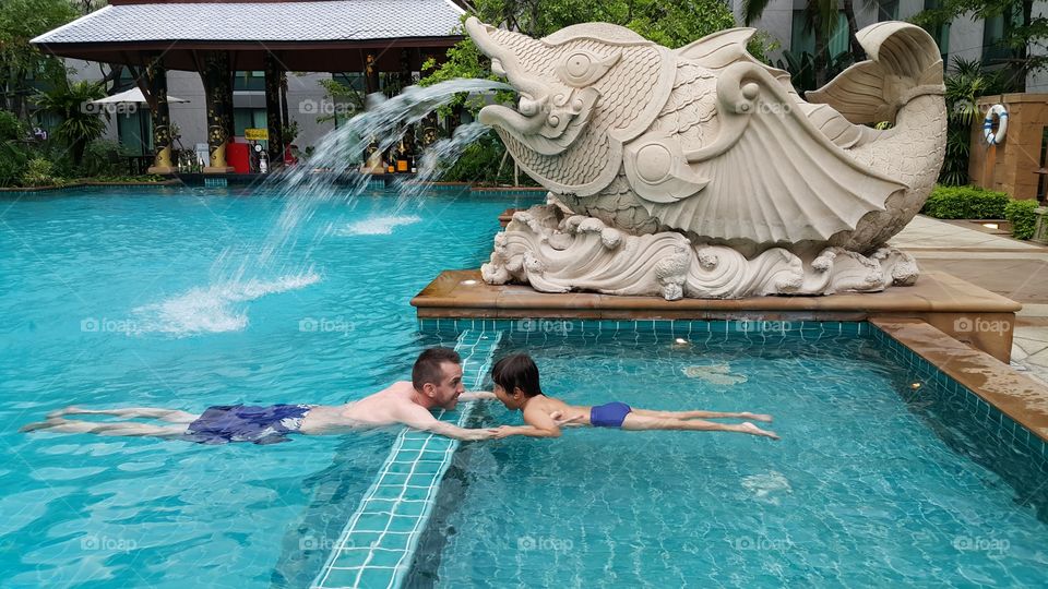 Pool time. father and son enjoy swimming