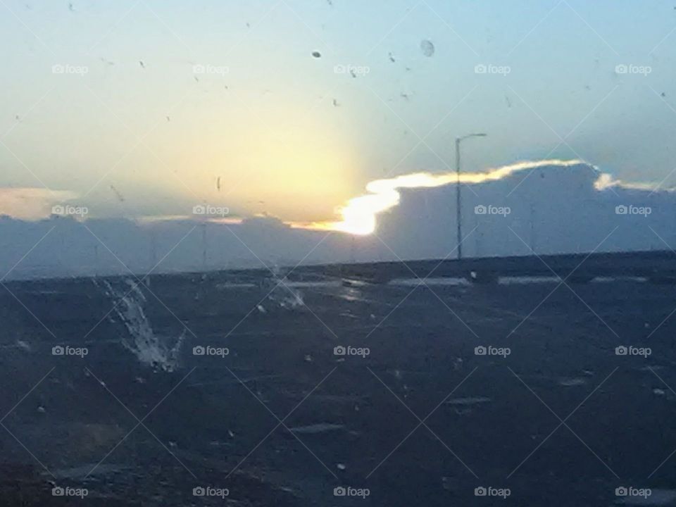 sunrise through a dirty windshield