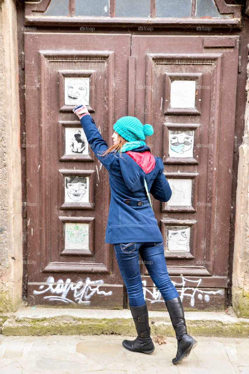 Girl is pointing at a drawing on a door