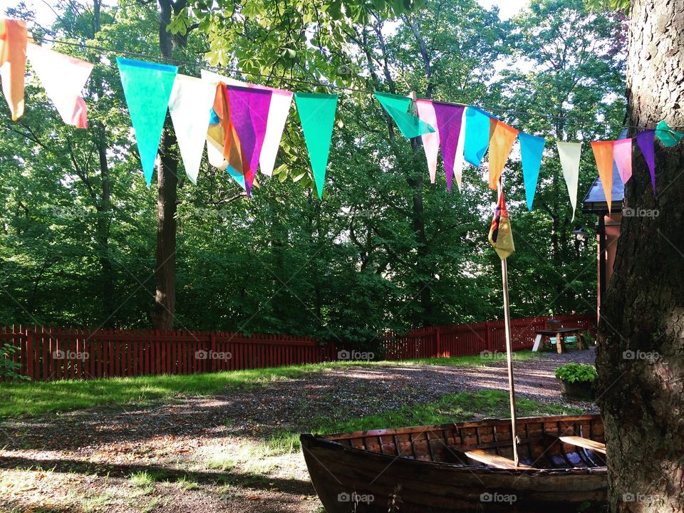 Garden with colorful pennants and skiff